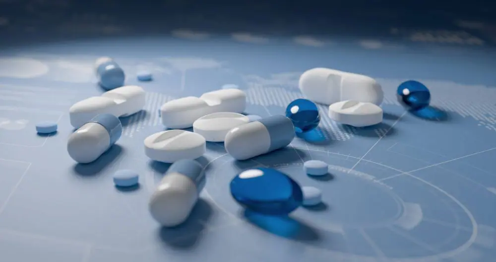 Pills, tablets and capsules on world map with charts blue background. International pharmaceutical research concept.