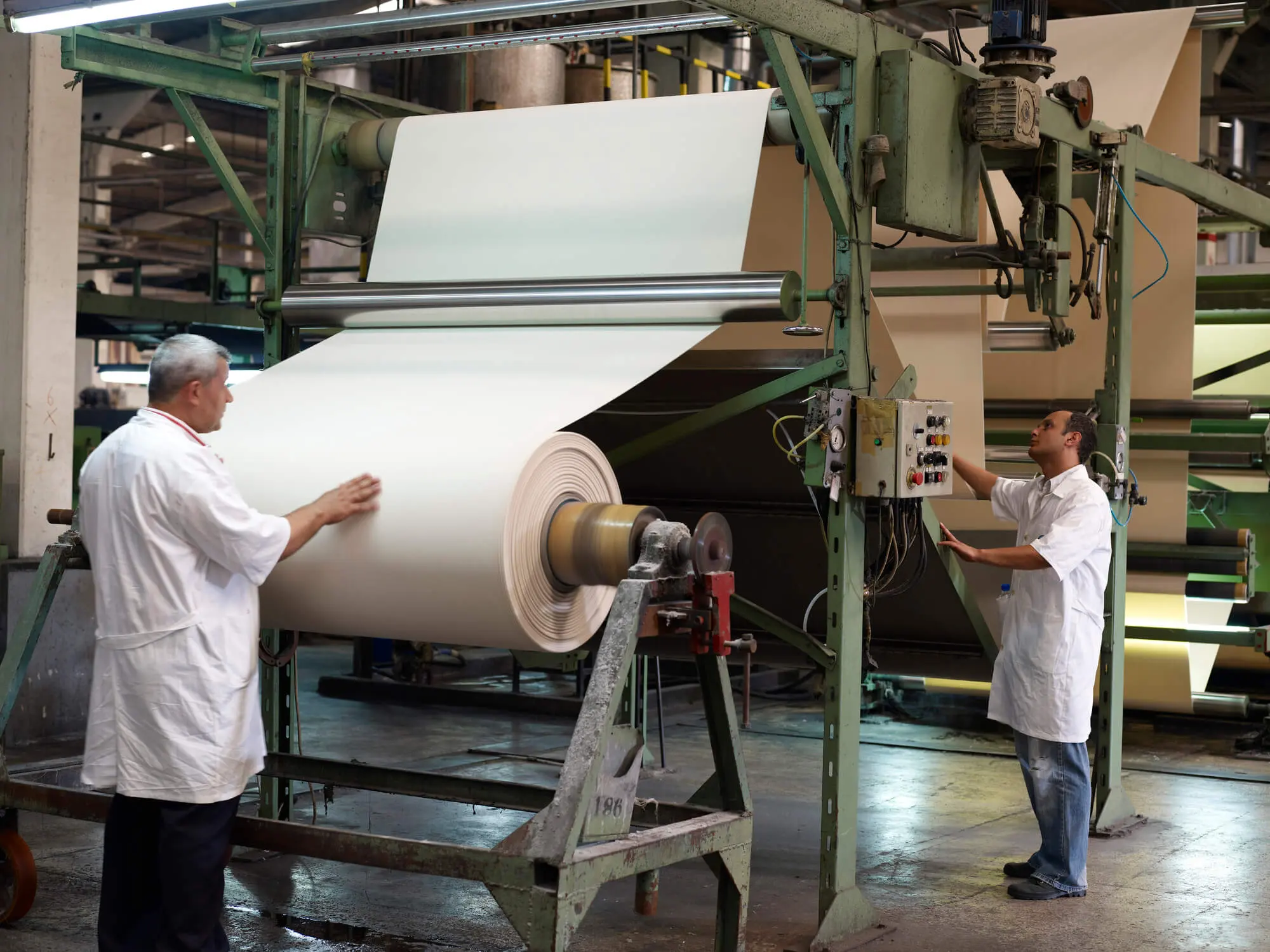 Workers working in front of a Textile Mill